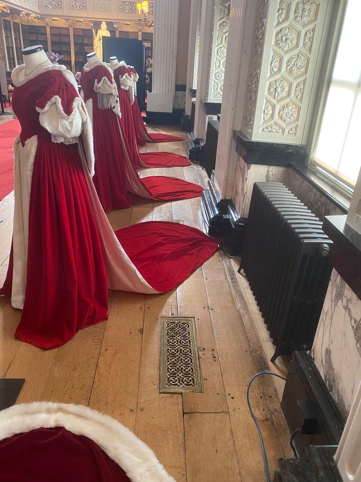 Coronation robe display beside marble panelling at Blenheim Palace