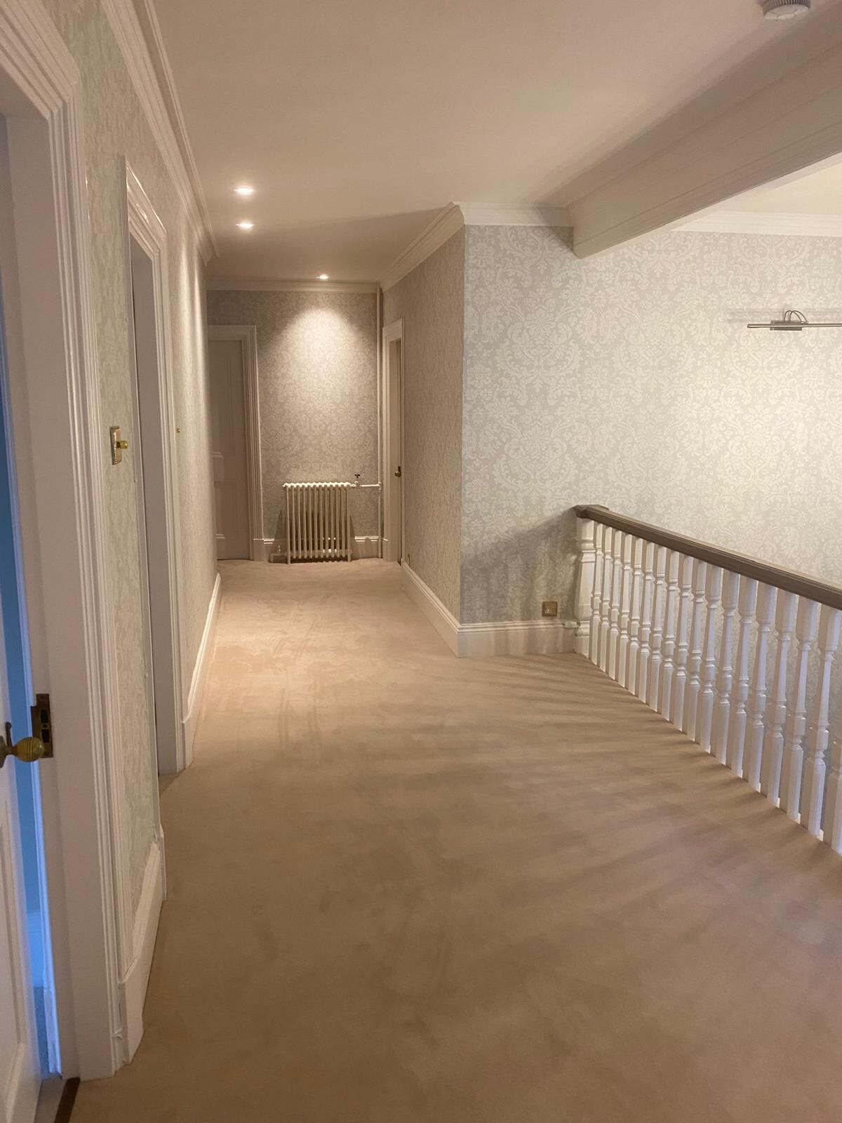 Damask wallpaper hung on first-floor landing of a Henley-on-Thames period property