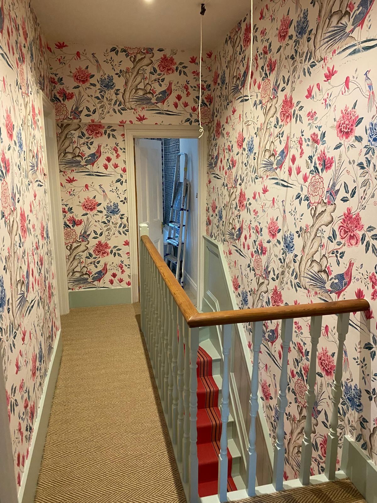 Pink and blue chinoiserie wallpaper hung on a Thames Valley staircase for an Elizabeth Cleall Interiors scheme